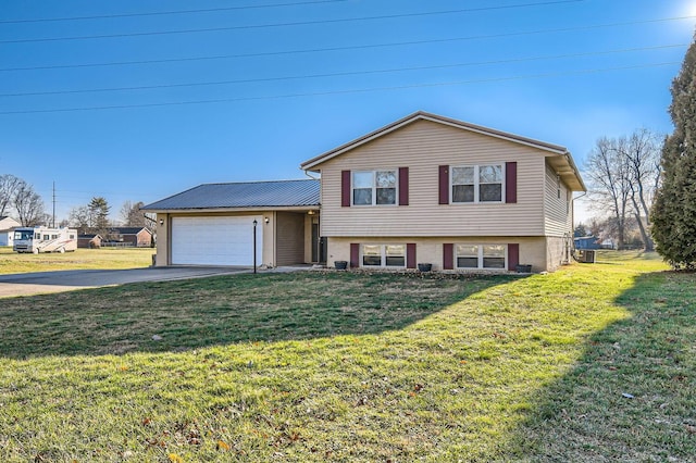 split level home featuring a garage and a front lawn