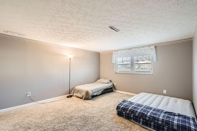 carpeted bedroom featuring a textured ceiling