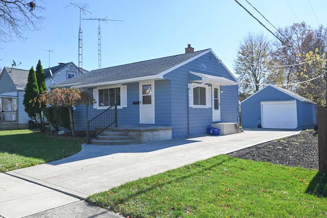 view of front of home featuring an outbuilding, a garage, and a front lawn