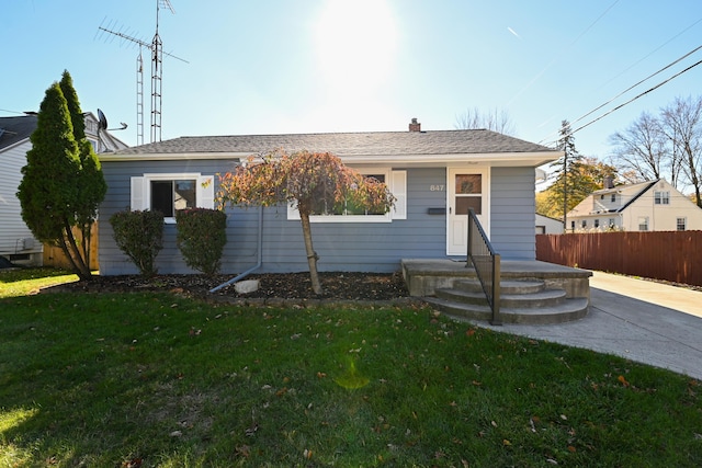 bungalow-style house featuring a front yard