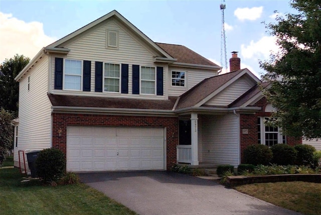 view of front of house with a garage and a front lawn