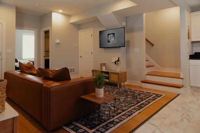 317 Johnson St, Columbus, OH 43203 - living room featuring stairs, light marble finish floors, and recessed lighting