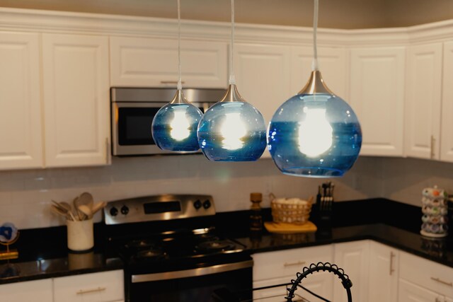 kitchen featuring appliances with stainless steel finishes and white cabinetry