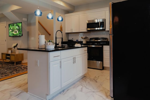 317 Johnson St, Columbus, OH 43203 - kitchen with appliances with stainless steel finishes, light marble finish flooring, white cabinets, and backsplash