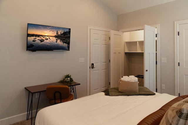 bedroom with carpet floors and vaulted ceiling