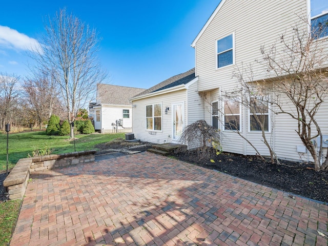 rear view of property featuring a yard and a patio