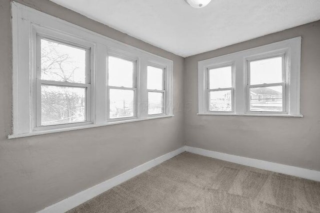 1371 E 23rd Ave, Columbus, OH 43211 - empty room with baseboards and carpet flooring
