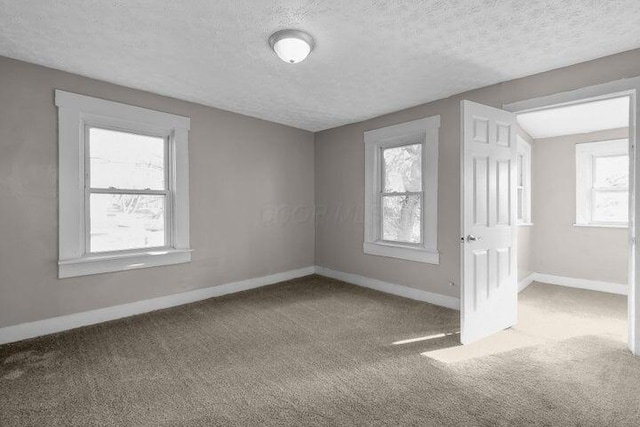 1371 E 23rd Ave, Columbus, OH 43211 - unfurnished bedroom with carpet floors, baseboards, and a textured ceiling
