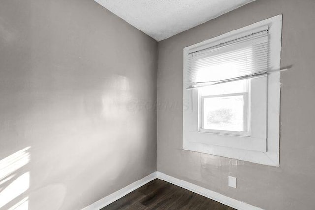 1371 E 23rd Ave, Columbus, OH 43211 - unfurnished room with baseboards and dark wood-style floors