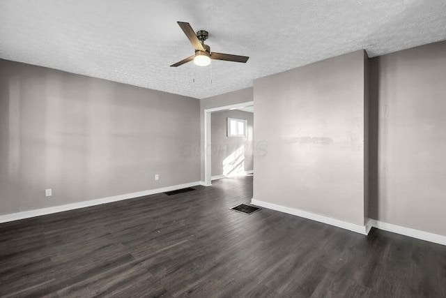 1371 E 23rd Ave, Columbus, OH 43211 - spare room with a textured ceiling, dark wood finished floors, a ceiling fan, and baseboards