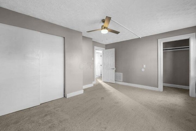 1371 E 23rd Ave, Columbus, OH 43211 - unfurnished bedroom with carpet flooring, a textured ceiling, baseboards, and ceiling fan