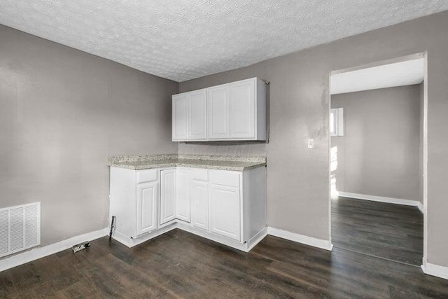1371 E 23rd Ave, Columbus, OH 43211 - laundry room featuring baseboards, dark wood-type flooring, and a textured ceiling