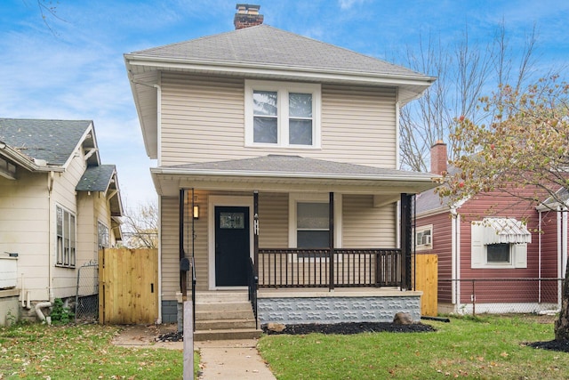 front of property featuring covered porch and a front lawn