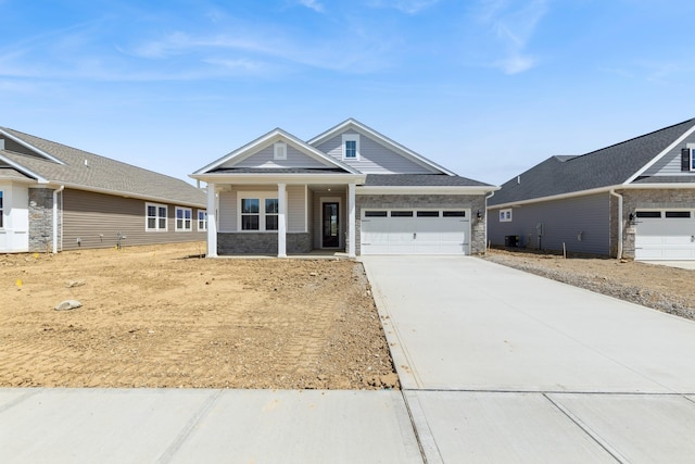 800 Heritage Blvd, Delaware, OH 43015 - craftsman house with a porch, a garage, driveway, and stone siding