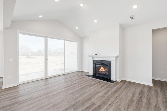 800 Heritage Blvd, Delaware, OH 43015 - unfurnished living room with recessed lighting, a fireplace with flush hearth, wood finished floors, and lofted ceiling