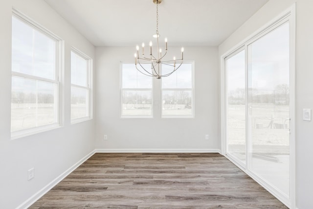 800 Heritage Blvd, Delaware, OH 43015 - unfurnished dining area featuring baseboards, wood finished floors, and a chandelier