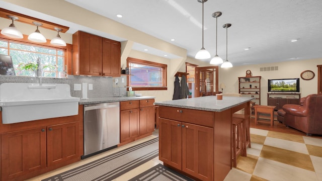 kitchen featuring dishwasher, a center island, sink, backsplash, and pendant lighting