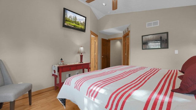 bedroom with ceiling fan, light hardwood / wood-style floors, and vaulted ceiling