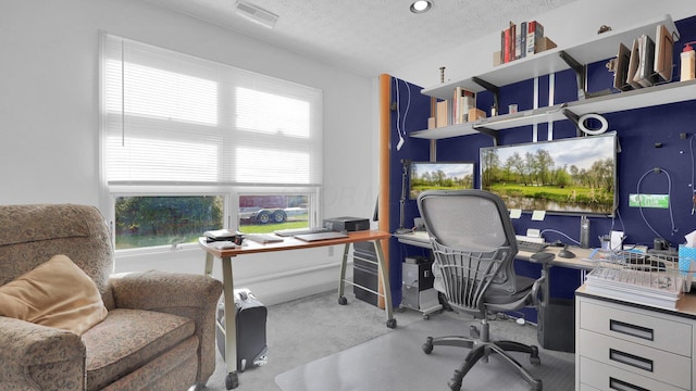 carpeted office space featuring a textured ceiling