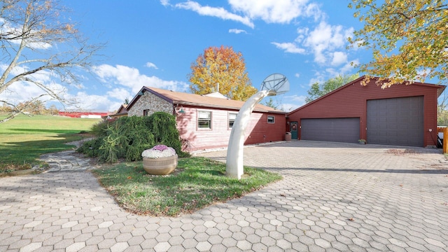 view of front facade with a garage and an outbuilding