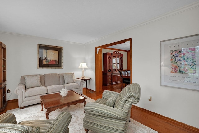 living room with baseboards, wood finished floors, and crown molding