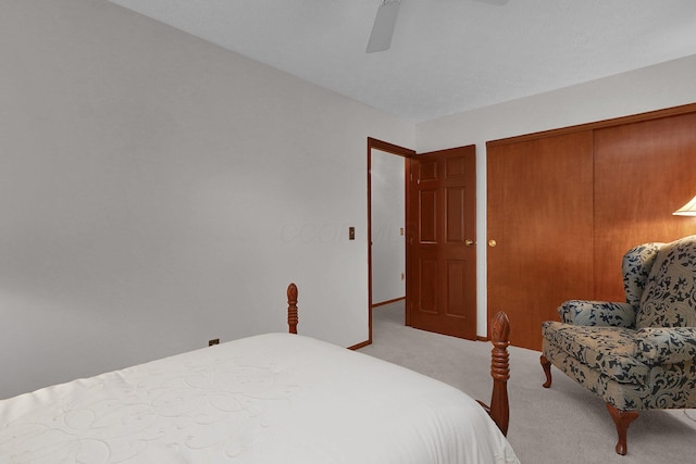 bedroom with a closet, a ceiling fan, and light colored carpet