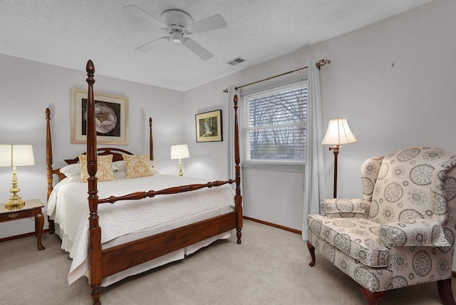 bedroom featuring a textured ceiling, baseboards, visible vents, ceiling fan, and carpet