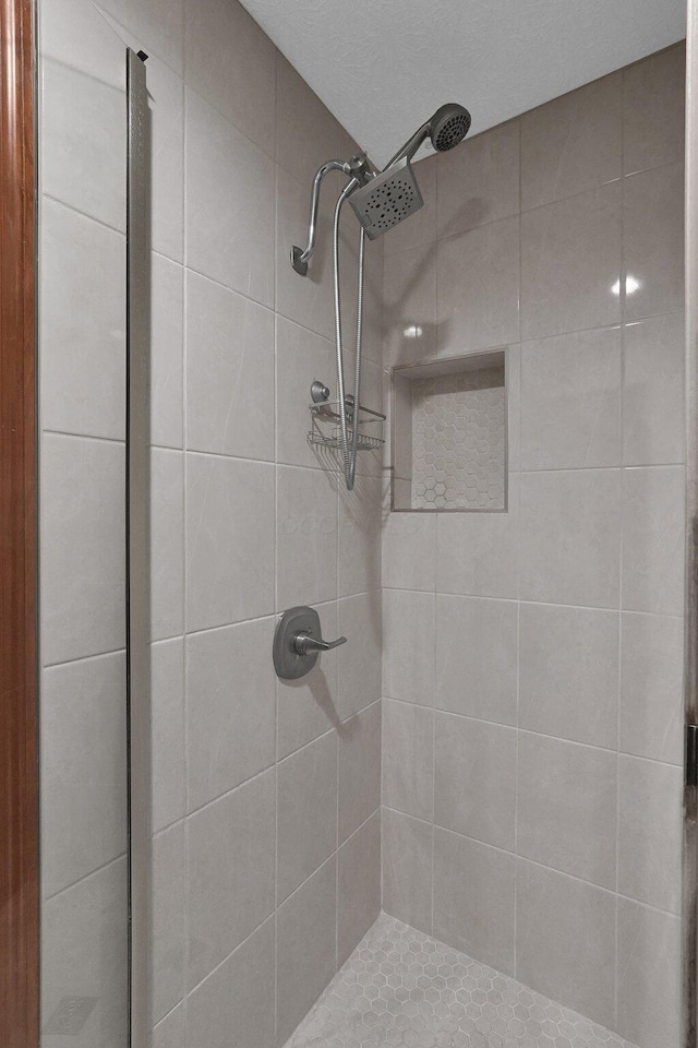 full bath featuring a tile shower