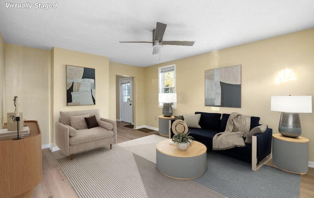 living room featuring hardwood / wood-style flooring and ceiling fan