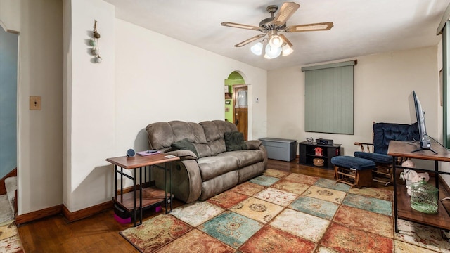 living room featuring hardwood / wood-style floors and ceiling fan