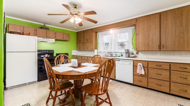 kitchen with decorative backsplash, ornamental molding, white appliances, ceiling fan, and sink