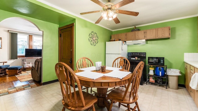 dining room with ceiling fan and crown molding