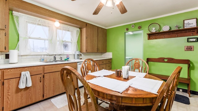 dining room with ceiling fan, ornamental molding, and sink