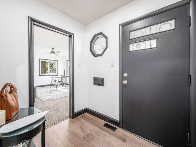 foyer featuring hardwood / wood-style floors, ceiling fan, and a wealth of natural light