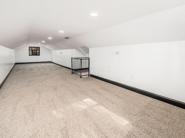 bonus room featuring carpet floors, a textured ceiling, and vaulted ceiling