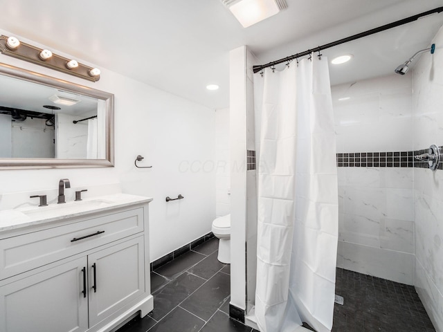 bathroom featuring curtained shower, vanity, and toilet