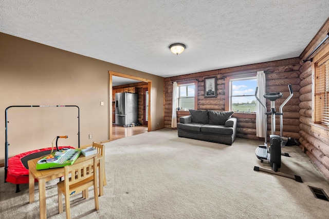 workout room with carpet flooring and a textured ceiling