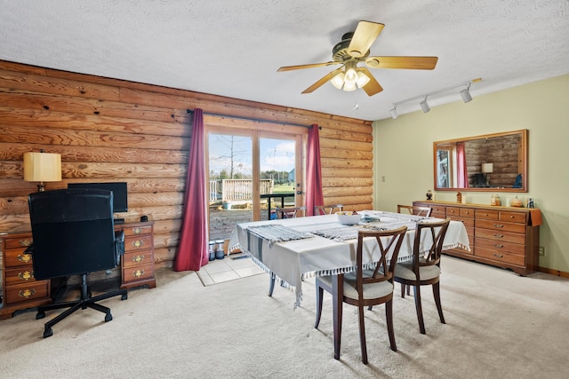 dining room featuring a textured ceiling, track lighting, and ceiling fan