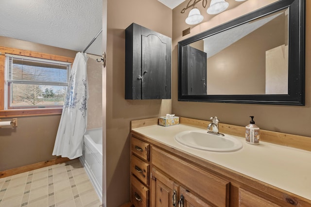 bathroom featuring vanity, shower / bathtub combination with curtain, and a textured ceiling