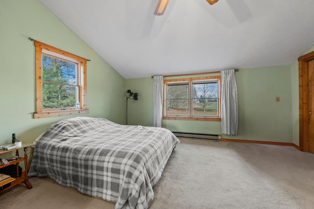 carpeted bedroom with multiple windows, a baseboard radiator, vaulted ceiling, and ceiling fan