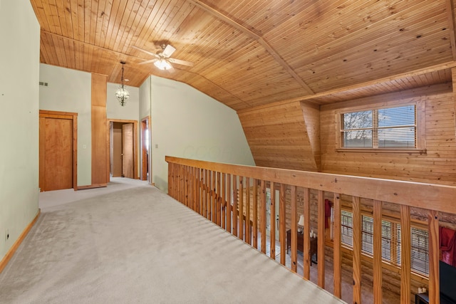 corridor with carpet flooring, wooden ceiling, and vaulted ceiling