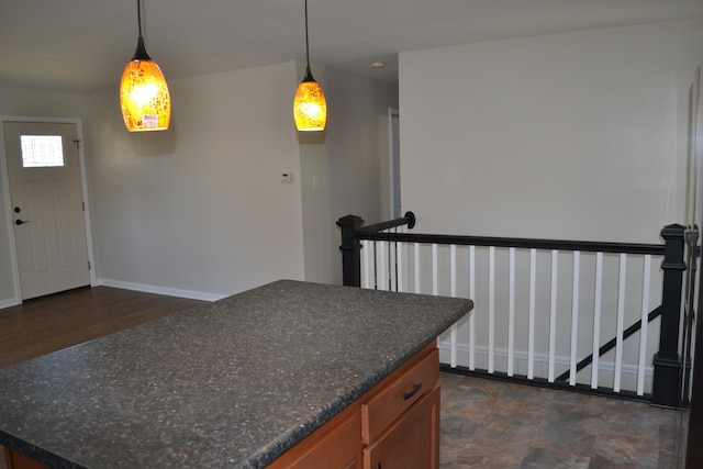 kitchen with decorative light fixtures and dark wood-type flooring