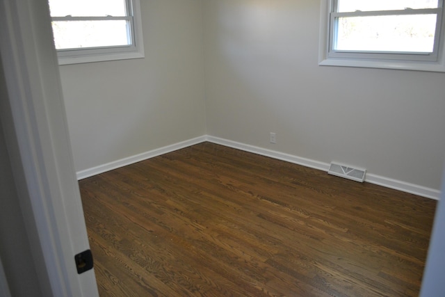 empty room featuring dark wood-type flooring