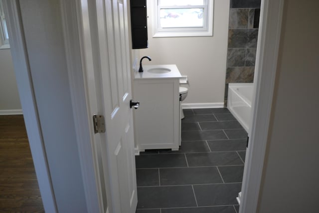 bathroom with tile patterned flooring, vanity, and toilet