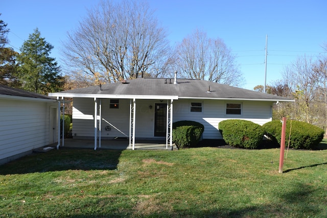 back of property with a patio area and a yard