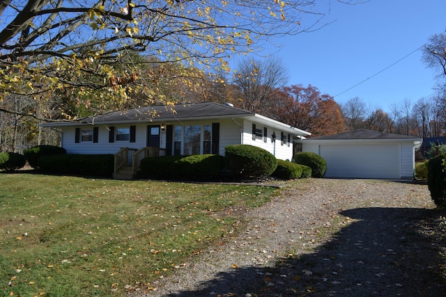 view of front of property with a garage, an outdoor structure, and a front yard