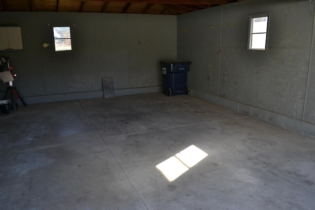 basement featuring wooden ceiling and a healthy amount of sunlight