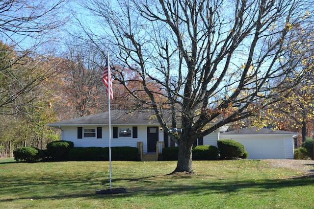 ranch-style home featuring a front lawn and a garage