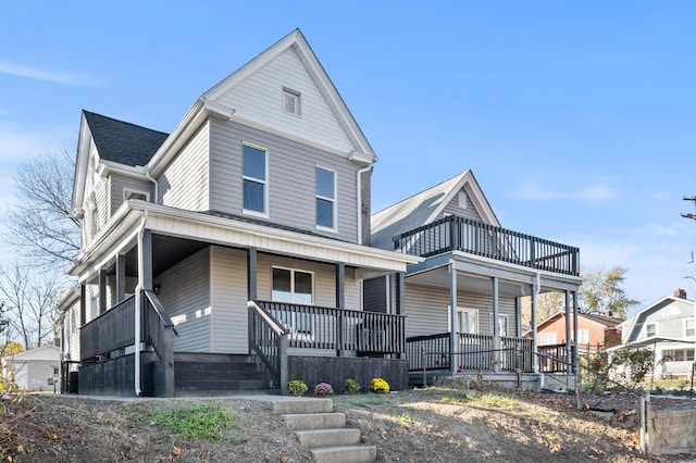 view of front of property with covered porch and a balcony