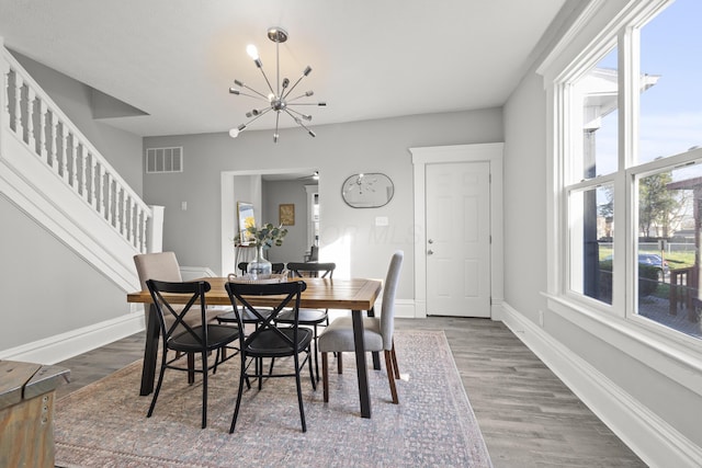 dining area featuring a notable chandelier and wood-type flooring